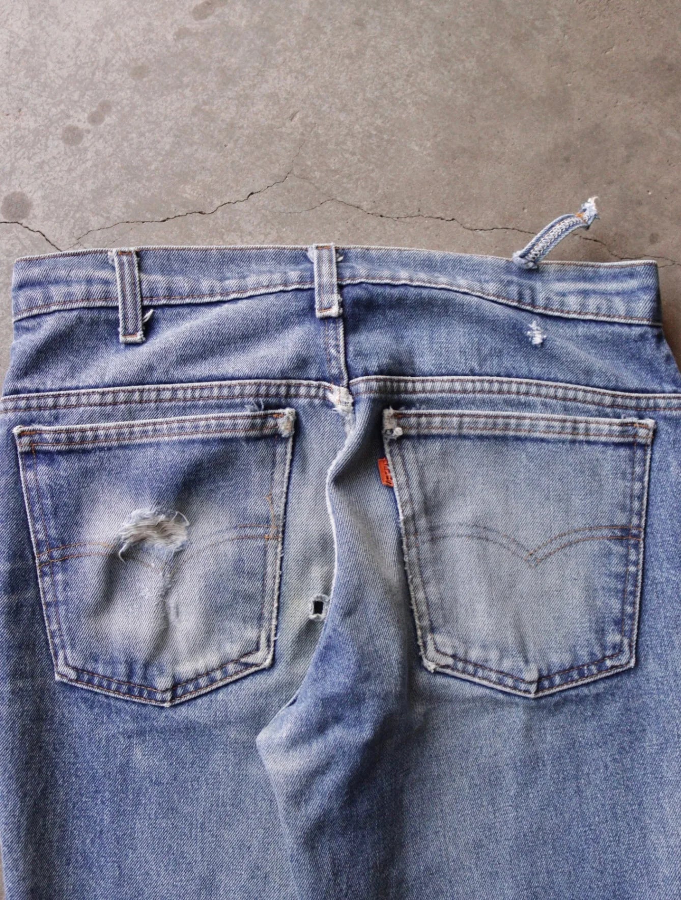 1970S DISTRESSED ORANGE TAB LEVI'S FLARED DENIM PANTS